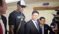 Flamboyant former NBA star Dennis Rodman (2nd L) of the US talks with Son Gwang-Ho (C), North Korea's vice minister for sports and culture, after his arrival at Pyongyang International Airport on June 13, 2017. AFP / Kim Won-Jin
