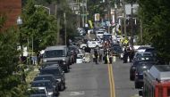 Alexandria police and emergency members gather near the crime scene of an early morning shooting in Alexandria, Virginia, June 14, 2017.   AFP / Brendan Smialowski
