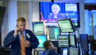 Traders work as a television monitor displays Federal Reserve Chair Janet Yellen announcing the Fed's decision to raise interest rates on the floor of the New York Stock Exchange (NYSE) in New York City