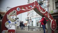 A girl poses for a picture in front of a banner promoting the 2017 Russia Confederations Cup football tournament in Kazan, Russia on June 16, 2017. / AFP / YURI CORTEZ
