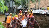 Bangladeshi firefighters carry a dead body at the site of a landslide in Rangamati on June 15, 2017. AFP