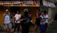 Philippine members of Special Weapons and Tactics (SWAT) patrol a neighborhood where evacuees from Marawi City are temporarily living in Iligan City on June 16, 2017. AFP / NOEL CELIS