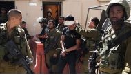 This file photo shows a Palestinian man arrested by Israeli soldiers in the occupied West Bank city of al-Khalil (Hebron). © AFP.