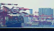 Container ships anchor at a pier in Tokyo port yesterday. Japan logged a surprise deficit of $1.8bn, despite market expectations for a surplus.