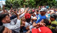 General Prosecutor's office employees (L) demonstrating in support of Attorney General Luisa Ortega face supporters of Venezuelan President Nicolas Maduro (R) in Caracas on June 19 , 2017. / AFP.