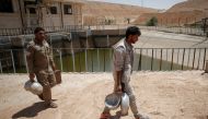 Members of Roj Mine Control Organization prepare explosive devices planted by Islamic State militants to be destroyed near Ain Issa village north of Raqqa, Syria, June 20, 2017. REUTERS/Goran Tomasevic
