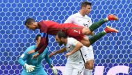 Portugal's forward Cristiano Ronaldo (L) falls over New Zealand's defender Andrew Durante after missing a goal during the 2017 Confederations Cup group A football match between New Zealand and Portugal at the Saint Petersburg Stadium in Saint Petersburg o