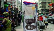 A towel with a print of the Nigerian naira is displayed for sale at a street market in the central business district in Nigeria