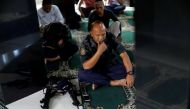 A Philippines police officer performs Eid al-Fitr prayers in a mosque inside the city hall compound in as government forces continue their assault against insurgents from the Maute group, who have taken over large parts of Marawi City , Philippines June 2