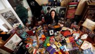 Harry Potter fan Victoria Maclean poses amongst her collection of merchandise at her home in Neath, Britain, February 9, 2017. (REUTERS/Neil Hall)
