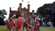 Australian Aborigines and Torres Strait Islanders wearing traditional dress stand in front of Government House after performing in a welcoming ceremony in Sydney, Australia, June 28, 2017. REUTERS/David Gray
