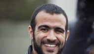 Omar Khadr smiles as he answers questions during a news conference after being released on bail in Edmonton, Alberta, May 7, 2015. Khadr, a Canadian, was once the youngest prisoner held on terror charges at Guantanamo Bay. REUTERS/Dan Riedlhuber