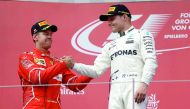 Valtteri Bottas celebrates his win on the podium with Ferrari's Sebastian Vettel at the Austrian Grand Prix at the Red Bull Ring in Spielberg, yesterday. 