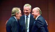 French Economy, Finance and Trade Minister Bruno Le Maire (centre) speaks with Italian Minister of Economy and Finance Pier Carlo Padoan (left) and Spain's Economy Minister Luis de Guindos, during a Eurogroup meeting at the European Union (EU) headquarter