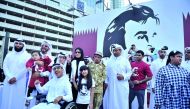 Amal bint Abdullatif Al Mannai, CEO of Qatar Foundation for Social Work Group, with supporters in front of the banner of Tamim Al Majd icon at the Tornado Tower yesterday.
Pic: Baher Amin / The Peninsula 