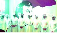 Ooredoo officials, pose before the image of the Emir H H Sheikh Tamim bin Hamad Al Thani, expressing solidarity with Qatar. 