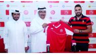 Syrian striker Mardik Mardikian (right) who signed a three-year contract with Al Arabi club poses for a picture during the unveiling ceremony in Doha.