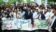 Lawyers shout slogans during a protest against Prime Minister Nawaz Sharif, in Lahore, yesterday.