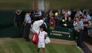 Switzerland's Roger Federer waves to the fans as he leaves the court after winning against Czech Republic's Tomas Berdych during their men's singles semi-final match on the eleventh day of the 2017 Wimbledon Championships at The All England Lawn Tennis Cl