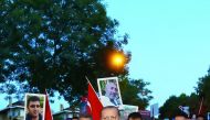 Turkey's President Recep Tayyip Erdogan (centre) and his wife Emine Erdogan walk to a ceremony site on Martyrs Bridge (Bosphorus Bridge) in Istanbul, yesterday. Turkey is marking one year of the defeated coup. 
