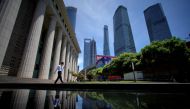 A man walks at Lujiazui financial district of Pudong in Shanghai, China July 17, 2017. (REUTERS/Aly Song)