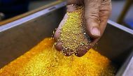 A worker checks gold granulate at a plant of gold refiner and bar manufacturer Valcambi SA in the southern Swiss town of Balerna.