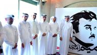 Sheikh Dr Khalid bin Thani bin Abdullah Al Thani, Chairman and Managing Director of QIIB, and Jamal Abdullah Al Jamal, Deputy CEO, with other officials at the launch of Tamim Al Majd mural yesterday. 