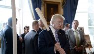 US President Donald Trump examines US-made products from all 50 states, including a Marucci baseball bat, in the Blue Room of the White House during a 
