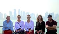 Student journalists Laura Clements, Claire Grinsell-Jones, Lucy Harrington, Alyssia Tennant, and Tom Storey pose with the Doha skyline as the backdrop. 