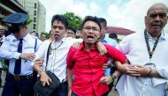 Activists are escorted from the Plenary Hall of the House of Representatives.