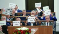 Opposition senators hold papers that read 'Independent Courts