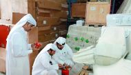 Officials of the Consumer Protection Department at the Ministry of Economy and Commerce conducting inspection at a shop in Salwa area, yesterday.