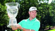 Grayson Murray of the United States celebrates with the trophy after winning on the 18th green during the final round of the Barbasol Championship at the Robert Trent Jones Golf Trail at Grand National on Sunday in Auburn, Alabama.
