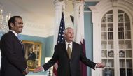 With Qatari Foreign Minister H E Sheikh Mohammed Bin Abdulrahman Al Thani looking on, US Secretary of State Rex Tillerson responds to a question on July 26, 2017 in Washington. When prompted by a reporter, Tillerson said 'I'm not going anywhere' and that 