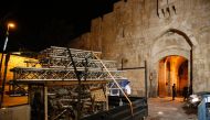 A truck removes the remaining barriers from the Al Aqsa mosque in Jerusalem on July 27, 2017. (AFP / AHMAD GHARABLI)