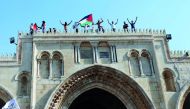 Palestinians gather inside the compound of Al Aqsa Mosque, after Israel removed all security measures it had installed at the compound, in Jerusalem’s Old City, yesterday.