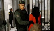 A suspect identified by bank employees as Wang Jing is led by a Spanish Civil Guard officer as they leave the headquarters of Industrial and Commercial Bank of China (ICBC) during a raid in Madrid, Spain, February 17, 2016. To match Special Report ICBC-SP
