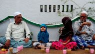 File photo of a young Indian child sitting with fellow Muslims as they prepare to break the fast with the Iftar meal during  Ramadan at The Wallajah Big Mosque in Chennai on July 1, 2016 (Reuters) 