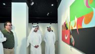 Katara General Manager Dr Khalid bin Ibrahim Al Sulaiti (centre) looks at the painting by Doha-based Syrian artist Rami Khouri at the opening of ‘Rhythm of the Alphabet’ exhibition yesterday at Katara Building 19. Pic: Baher Amin / The Peninsula