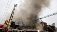 Firefighters operate at the fire site at Tokyo's Tsukiji fish market in Tokyo, Japan August 3, 2017. (REUTERS/Toru Hanai)