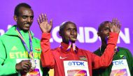 From left: Silver medallist Ethiopia’s Tamirat Tola, gold medallist Kenya’s Geoffrey Kipkorir Kirui and bronze medallist Tanzania’s Alphonce Felix Simbu take part in a medal ceremony after the men’s marathon athletics event at the 2017 IAAF World Champion