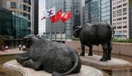 FILE PHOTO: (L-R) The Hong Kong Exchanges flag, Chinese national flag and Hong Kong flag are hoisted outside the Hong Kong Stocks Exchange in Hong Kong June 7, 2016. Reuters/Bobby Yip