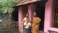 Kavita stands with her youngest daughter outside their home after her husband, a landless farmer, died last year when the crops failed amidst the worst drought in more than a century in Nagapattinam, India. July 7, 2017. Thomson Reuters Foundation/Rina Ch