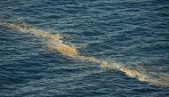 A picture taken with a drone shows a spot on the sea surface caused by micro-algae off the coast of Guimar, on August 5, 2017 on the Spanish Canary island of Tenerife. AFP / Desiree Martin