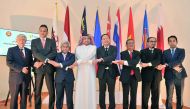 Thailand Ambassador and ACD Chairman Soonthorn Chaiyindeepum (fourth right), Ibrahim Fakhroo, Director of Protocol at the Ministry of Foreign Affairs (fourth left) and other Asean ambassadors in the traditional Asean handshake during celebrations of the b