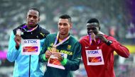 Bronze medallist Abdalelah Haroun of Qatar (right) Silver medallist Steven Gardiner of the Bahamas (left) and gold medallist Wayde Van Niekerk of South Africa pose with their medals during the victory ceremony of the Men’s 400 metres of the IAAF Athletics