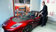 Toyota President Akio Toyoda (left) is presented with the keys to a Tesla Roadster by Tesla CEO Elon Musk in this file picture.