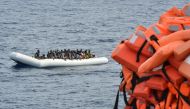 Migrants on a rubber boat waiting to be evacuated during a rescue operation by the crew of the Topaz Responder on November 5, 2016 off the coast of Libya. (AFP/Andreas Solaro)