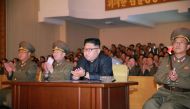 This picture taken on August 14, 2017 and released from North Korea's official Korean Central News Agency (KCNA) on August 15, 2017 shows North Korean leader Kim Jong-Un (C) clapping hands while viewing a stage during his inspecting the Command of the Str