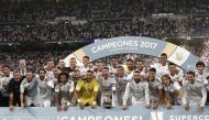 Players and the technical team of Real Madrid pose for a photo as they celebrate winning the Spanish Super Cup in the return match against Barcelona at Santiago Bernabeu Stadium in Madrid, Spain on August 17, 2017. (Burak Akbulut - Anadolu Agency)